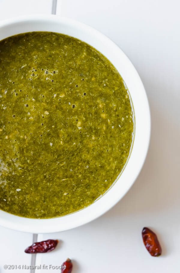 45 degree angle view of 2 bowls of Trinidad callaloo soup. Two books in the background.