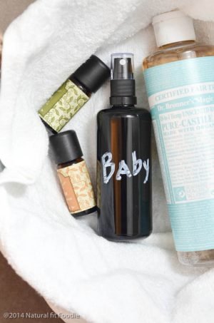 straight on shot of dark spray bottle with homemade highchair cleaner , castile soap and essential oils